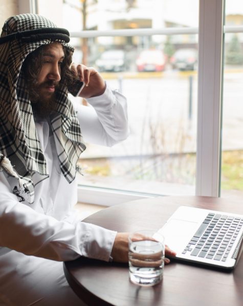 Arabian businessman working in office, business centre using devicesm gadgets. Lifestyle